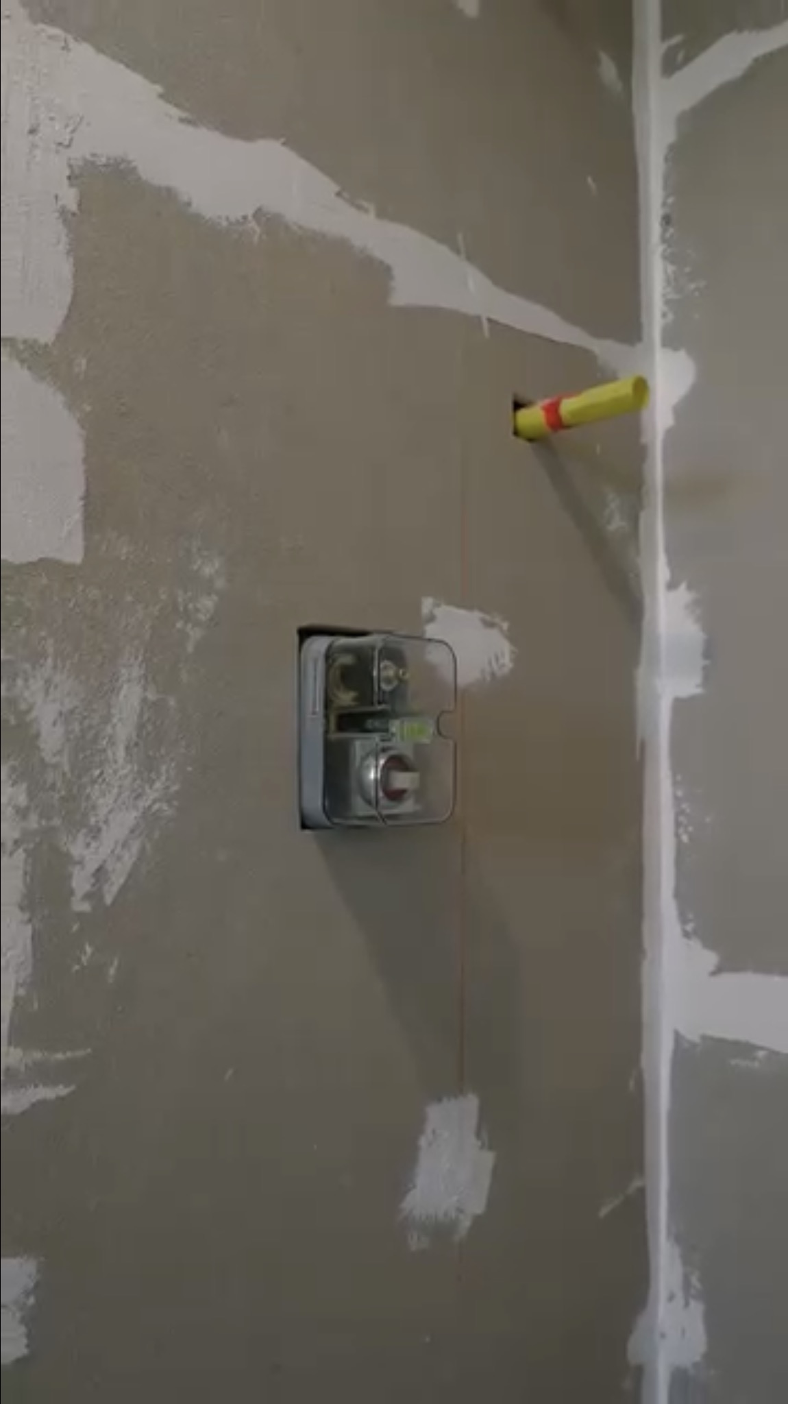 Rough-in stage — drywall and plumbing before tile